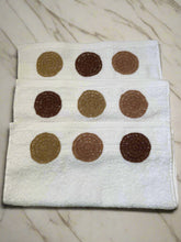 Load image into Gallery viewer, Three white towels with brown circular patterns on a beige background