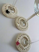 Load image into Gallery viewer, Three crocheted wine glass coasters on a textured surface
