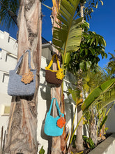 Load image into Gallery viewer, Three woven bags on a palm tree with a clear blue sky.