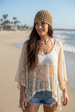 Load image into Gallery viewer, woman at the beach wearing a beige shimmery gold crochet mesh hat