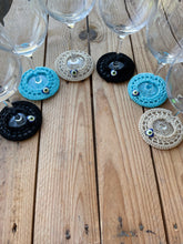 Load image into Gallery viewer, Decorative glass coasters on a wooden surface with wine glasses.
