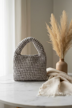 Load image into Gallery viewer, a handmade crochet bag on a white table