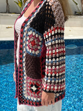 Load image into Gallery viewer, Multicolored crochet clutch cardigan with a pool in the background