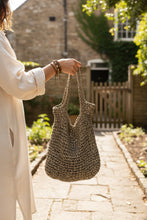 Load image into Gallery viewer, Person holding a crochet bag