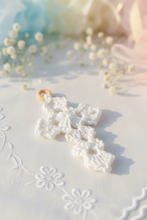 Load image into Gallery viewer, A white crocheted cross with a small wooden ring to be hanged on the wall