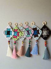 Load image into Gallery viewer, Crocheted wall hanging with colorful granny squares and tassels on a plain background