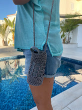 Load image into Gallery viewer, Person wearing a blue shirt and gray knit sleeves by a poolside.