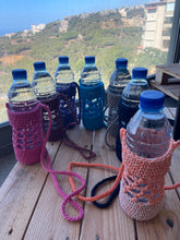 Load image into Gallery viewer, Bottles with colorful knitted covers on a plain background
