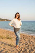 Load image into Gallery viewer, Person wearing blue jeans with a textured pattern on a white surface.