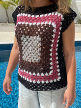 Load image into Gallery viewer, Person holding a crocheted bag with a heart design by a pool.