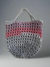 Load image into Gallery viewer, Crocheted bag with gray and pink pattern on a gray background