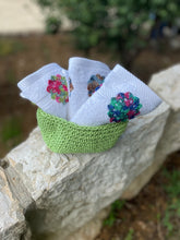 Load image into Gallery viewer, Green knitted bowl with embroidered towels on a stone ledge outdoors