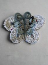 Load image into Gallery viewer, Crocheted butterfly bag charm on a textured fabric background