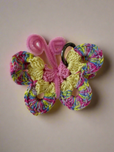 Load image into Gallery viewer, Colorful butterfly-shaped keychain on a textured white surface