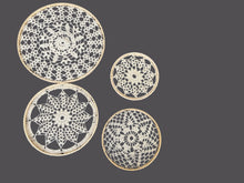 Load image into Gallery viewer, Four crocheted doilies of different sizes on a dark gray background