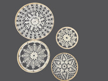 Load image into Gallery viewer, Four lace doilies of different sizes on a gray background