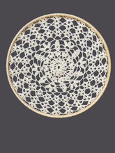 Load image into Gallery viewer, Round woven doily with black and white pattern on a gray background