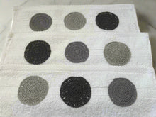 Load image into Gallery viewer, Set of gray and black circular coasters on a white towel