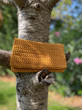 Load image into Gallery viewer, Mustard yellow crochet pouch attached to a tree trunk with a blurred natural background