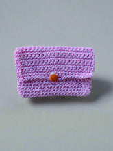 Load image into Gallery viewer, Pink knitted pouch with a small orange ladybug button