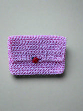 Load image into Gallery viewer, Pink knitted pouch with a ladybug on a wooden surface