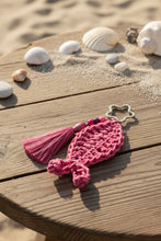 Load image into Gallery viewer, Pink crocheted keychain with a star-shaped ring on a gray surface