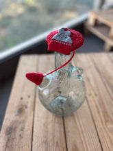 Load image into Gallery viewer, Decorative glass bottle with red heart-shaped stopper on a wooden surface