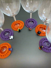 Load image into Gallery viewer, Wine glasses with Halloween-themed crochet coasters on a gray surface