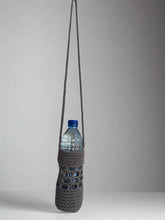 Load image into Gallery viewer, Textured bottle holder with a water bottle on a gray background