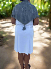 Load image into Gallery viewer, Person wearing a gray crocheted shawl over a white dress in a natural setting
