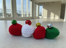 Load image into Gallery viewer, Crocheted ornaments with colorful bells on a light gray background