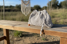 Load image into Gallery viewer, Crocheted bag with wooden beads on a stone surface