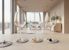 Load image into Gallery viewer, Wine glasses with crochet doily coasters on a concrete surface