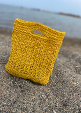 Load image into Gallery viewer, Yellow crochet bag on a sandy surface with a blurred background