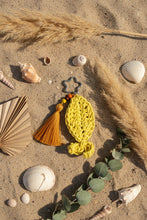 Load image into Gallery viewer, Yellow crocheted keychain with a tassel on a gray background