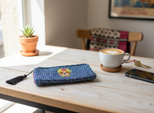 Load image into Gallery viewer, Blue crochet wallet with skull badge lifestyle setting