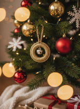 Load image into Gallery viewer, Gold shimmery crochet Christmas ornament with silver bell on tree