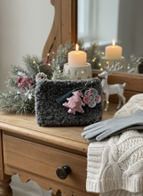 Load image into Gallery viewer, Gray winter crochet clutch standing in lifestyle setting