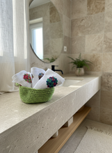 Load image into Gallery viewer, Green crochet basket with towels in bathroom setting