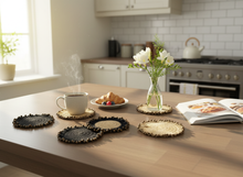 Load image into Gallery viewer, Kitchen table lifestyle scene with crochet coasters