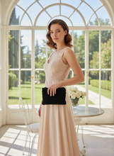 Load image into Gallery viewer, Lady in Light Dress Holding Black Crochet Clutch