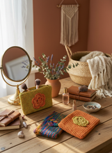 Load image into Gallery viewer, Lifestyle scene with colorful crochet pouches
