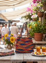 Load image into Gallery viewer, Multicolored crochet shoulder bag in vibrant lifestyle setting
