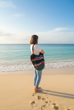 Load image into Gallery viewer, Woman at the beach wearing a Multicolored Polyester Net Crochet Beach Bag