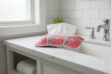 Load image into Gallery viewer, Tissue holder with pink and gray crochet cover in a bathroom