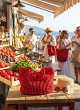 Load image into Gallery viewer, Red Net Polyester Crochet Bag Lifestyle - Handmade Beach Market Tote | CKKoetter