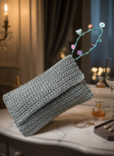 Load image into Gallery viewer, Shimmering crochet clutch with beaded strap in elegant setting
