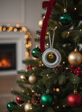 Load image into Gallery viewer, Silver shimmery crochet Christmas ornament with golden bell on tree