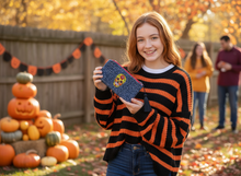 Load image into Gallery viewer, Teenager holding blue skull wallet in Halloween setting