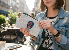 Load image into Gallery viewer, Teenager holding white silver crochet wallet with skull badge